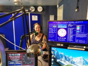 phptp of smiling woman in the radio studio