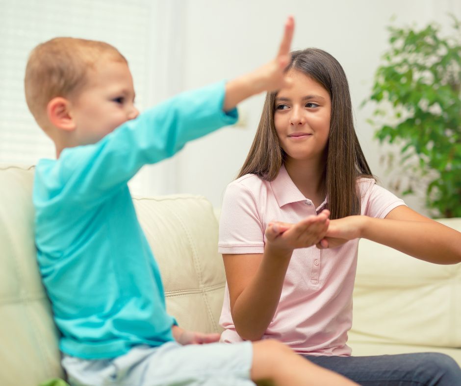 Two children using sign language together